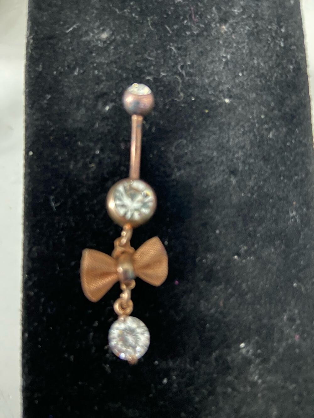 Belly button ring with bow copper tone